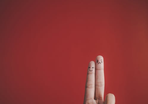Finger with emotion on red background. photo