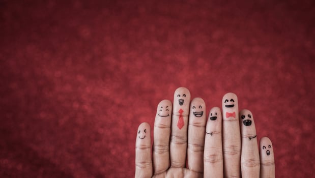 Finger with emotion on red background. photo