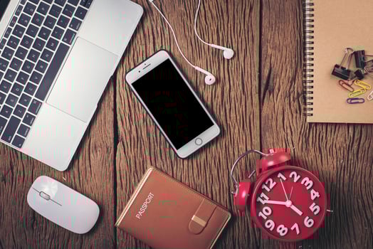 Top view phone and workspace on wood background. photo