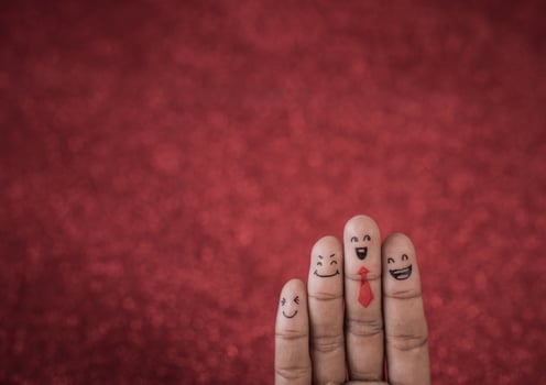 Finger with emotion on red background. photo