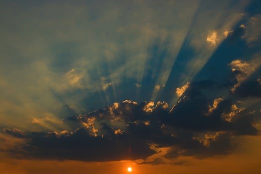 Beautiful sky with clouds and sun rays at sunset photo