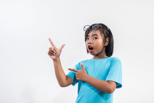 Portrait of Funny little girl acting in studio shot. photo
