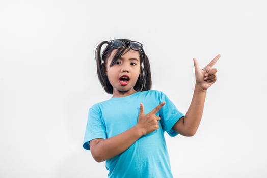 Portrait of Funny little girl acting in studio shot. photo