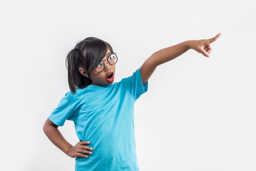 Portrait of Funny little girl acting in studio shot. photo