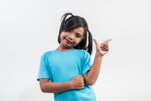 Portrait of Funny little girl acting in studio shot. photo
