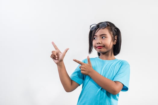Portrait of Funny little girl acting in studio shot. photo