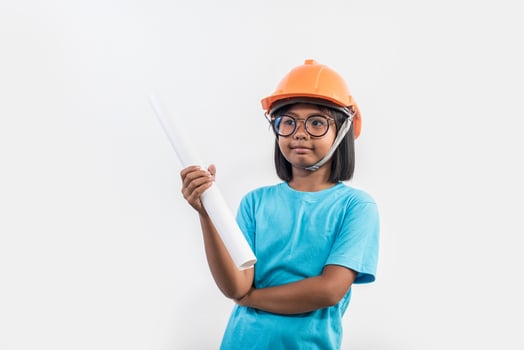 Little girl wearing orange helmet in studio shot. photo