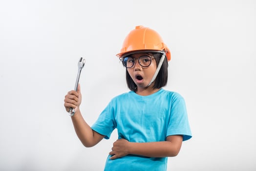 Little girl wearing orange helmet in studio shot. photo