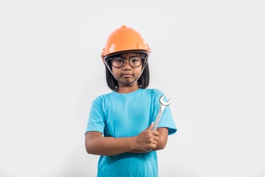 Little girl wearing orange helmet in studio shot. photo