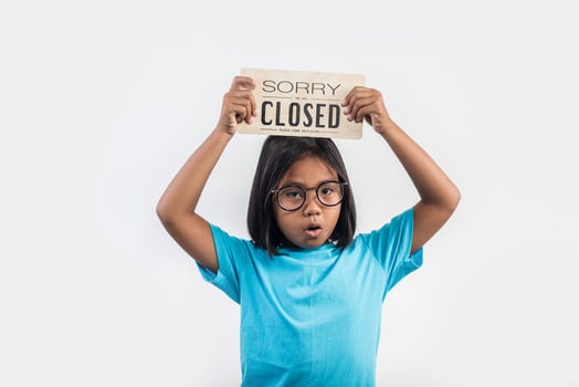 Little girl hand holding wood sign closed. photo