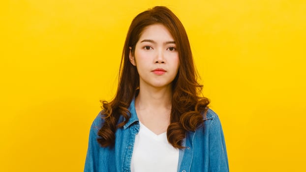 Asian female with positive expression over yellow background. photo