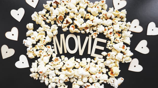 Popcorn on black background. Watching a movie with popcorn photo