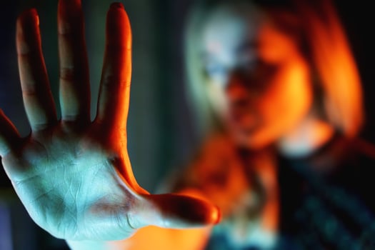 Young woman showing her denial with NO on her hand photo