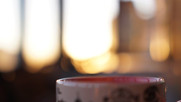 Blurred background with a window and a cup of tea photo