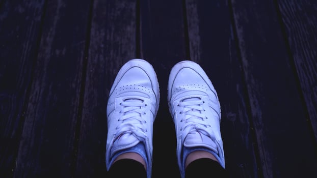 Fashion hipster cool woman with white sneakers, vintage toned colors photo