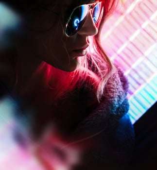 Beautiful Young Girl. Attractive Girl with Glasses by Neon Lights photo
