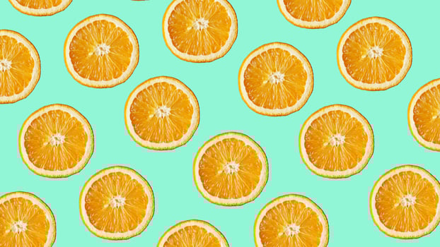 Colorful fruit pattern of fresh orange slices on blue photo