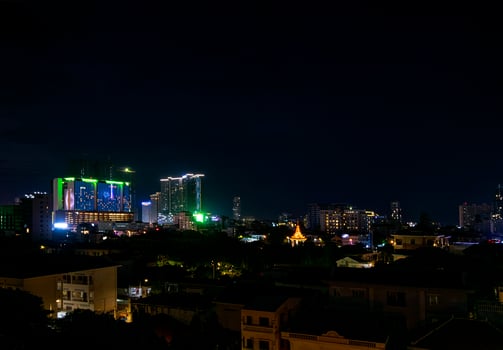 Downtown central Phnom Penh city night view in Cambodia with Naga World casino complex and Koh Pich Diamond Island skyline photo