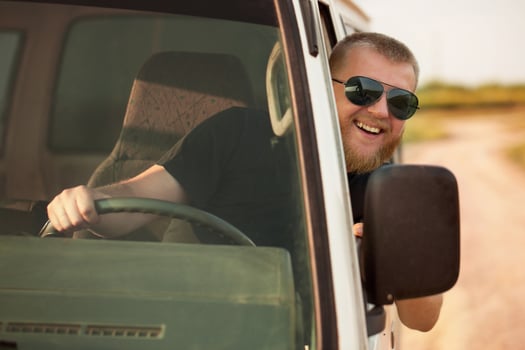 Cheerful driver behind the wheel of his car photo