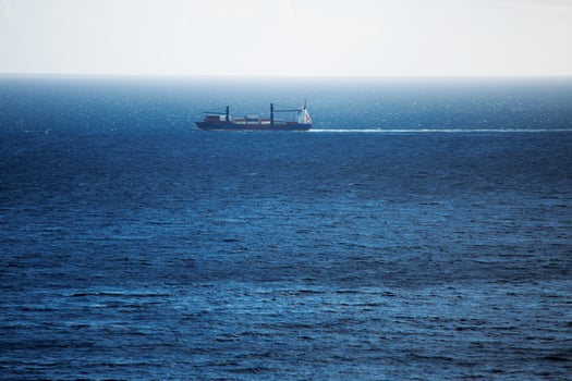 Cargo ship carries swims across the ocean photo