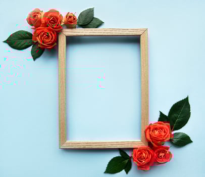 Flowers composition. Wooden frame and red  roses photo