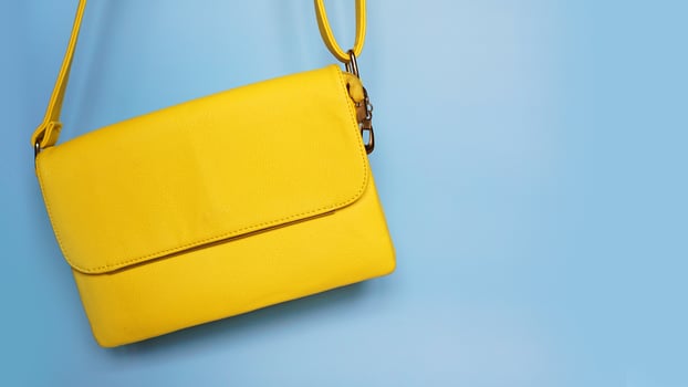 Yellow fashion female woman purse handbag on blue photo