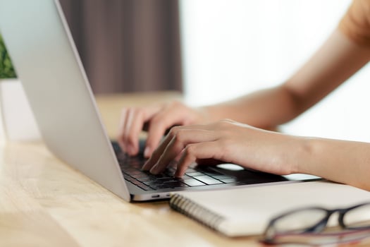 Woman typing on laptop keyboard photo