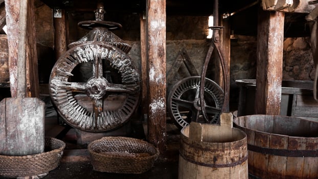 An ancient hand mill made of stones and wood. Flour grinding device photo