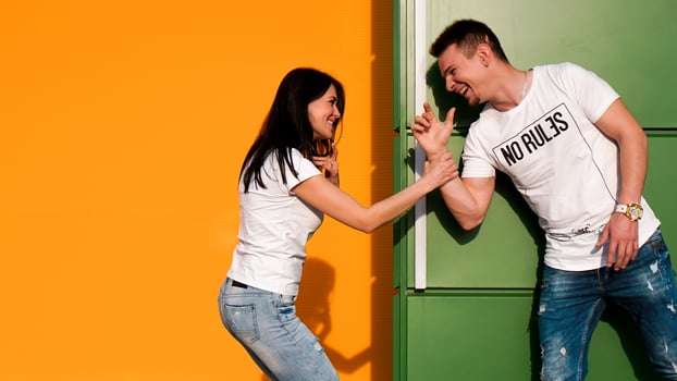 Young couple in love hiding from each other. The girl scared the guy photo