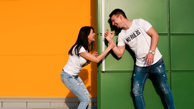 Young couple in love hiding from each other. The girl scared the guy photo