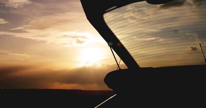 Outdoor car trunk at sunset, photo against the sun