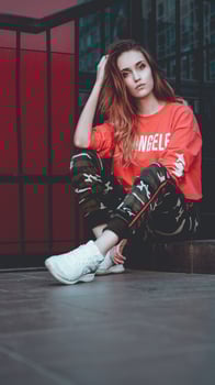 Fashion model wearing red hoodie with inscription los angeles photo