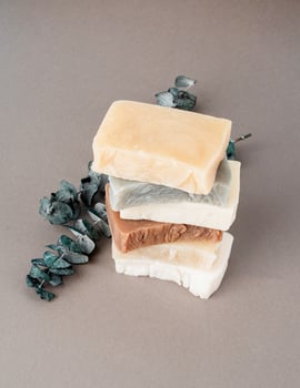 Stack of hand made soap and eucalyptus on gray background photo