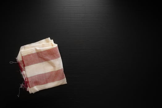 Red napkin on dark wooden table. Copy space photo