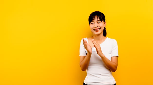 Congratulation portrait of an asian woman with joy clapping photo