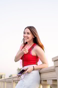 Girl standing in the park listening to the music and chatting photo