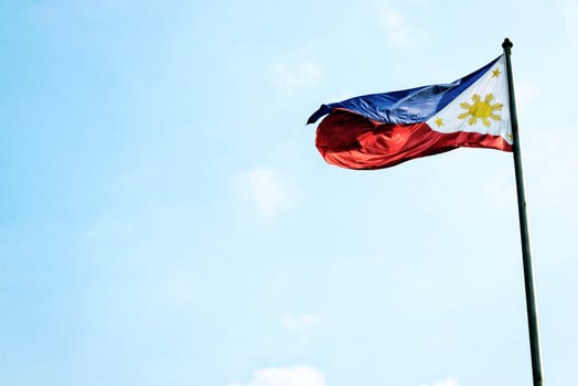 Philippines Filipino flag flying on flagpole in Manila photo