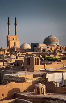 Rooftops downtown mosque and landscape view of Yazd city old town in Iran photo