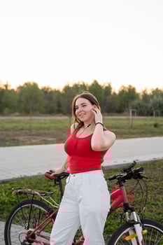 Teenage girl with her bike listening to the music photo
