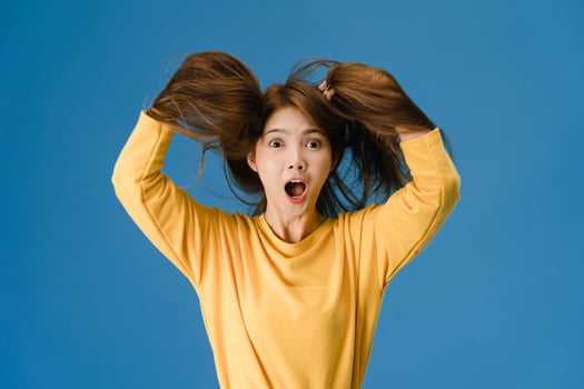 Young lady feeling happiness joyful surprise funky on blue background. photo