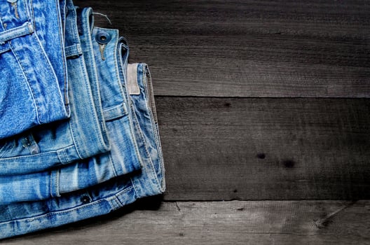 Blue jean and jean lack texture on table, Jeans are overlapping. photo