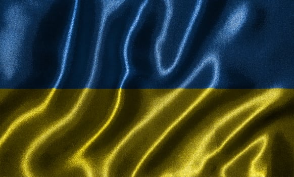 Wallpaper by Ukraine flag and waving flag by fabric. photo