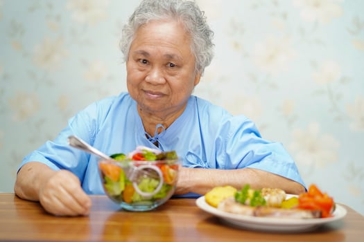 Asian senior woman patient eating breakfast in hospital. photo