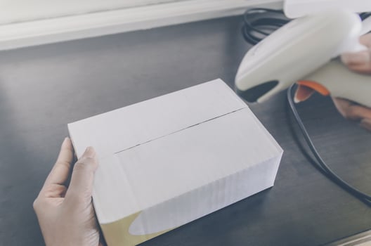 A human hand holding parcel with barcode reader for delivery. photo