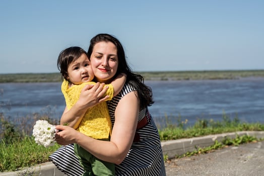Happy Young Mixed Race Ethnic Family Walking In The Park by the river photo