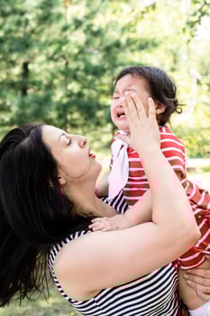 Mother calming her crying daughter photo