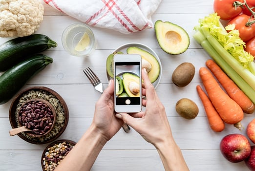 Female hands taking a picture of healthy food top view flat lay photo