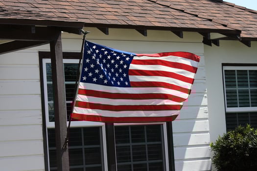 The Star-Spangled Banner at the front door of an American house photo