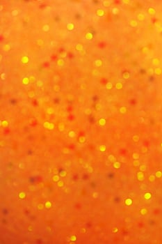 Defocus light orange glitter. Abstract light background photo