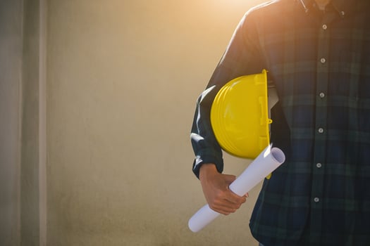 Close up Businessman holding yellow hard hat builder photo
